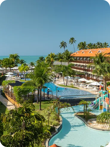 Family playing in the resort's pool with a colorful slide.