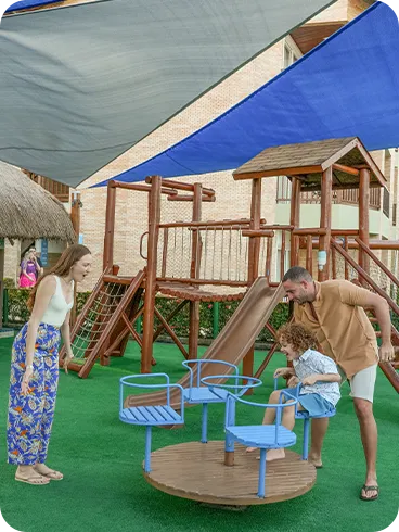Family having fun in the pool at Salinas Maceió with the child on the father's back.