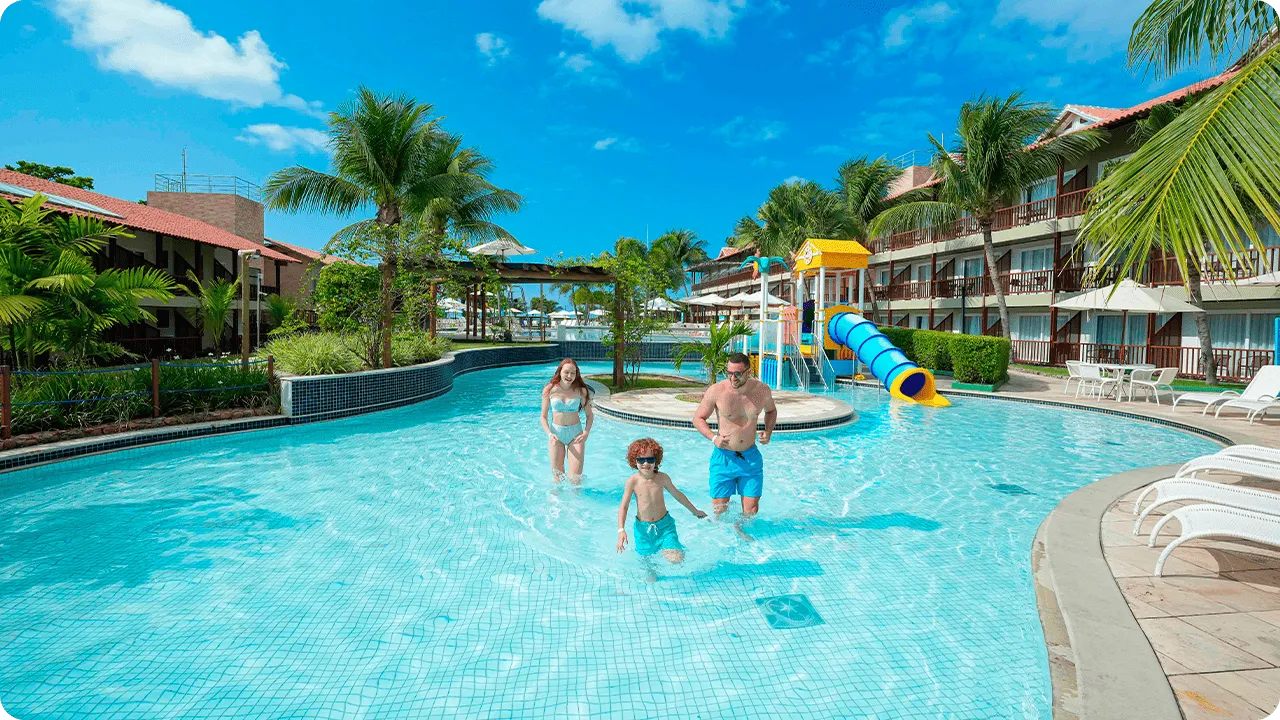 Family playing a game of foosball at Clubinho do Siri, the resort's kids' club.