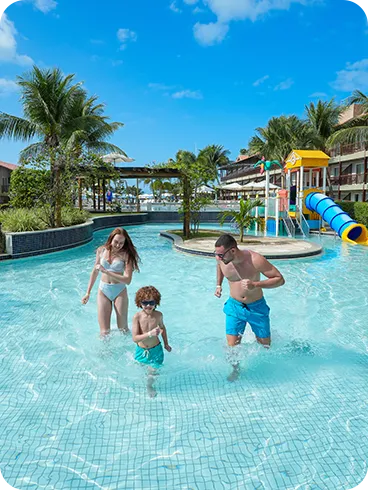 Family playing a game of foosball at Clubinho do Siri, the resort's kids' club.