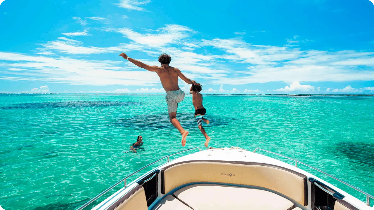 Family having fun on a speedboat ride in the crystal-clear waters of Maragogi