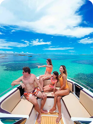 Family having fun on a speedboat ride in the crystal-clear waters of Maragogi