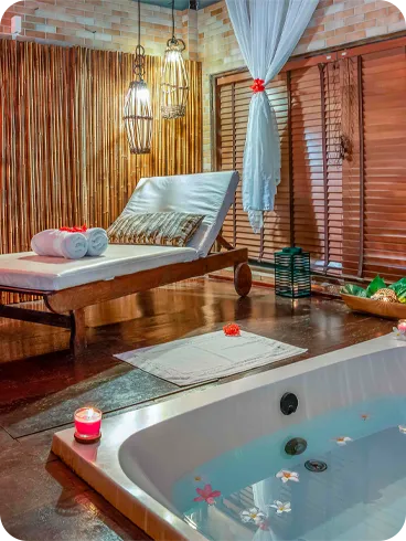 Spa com banheira de hidromassagem e ambiente decorado com velas e flores
