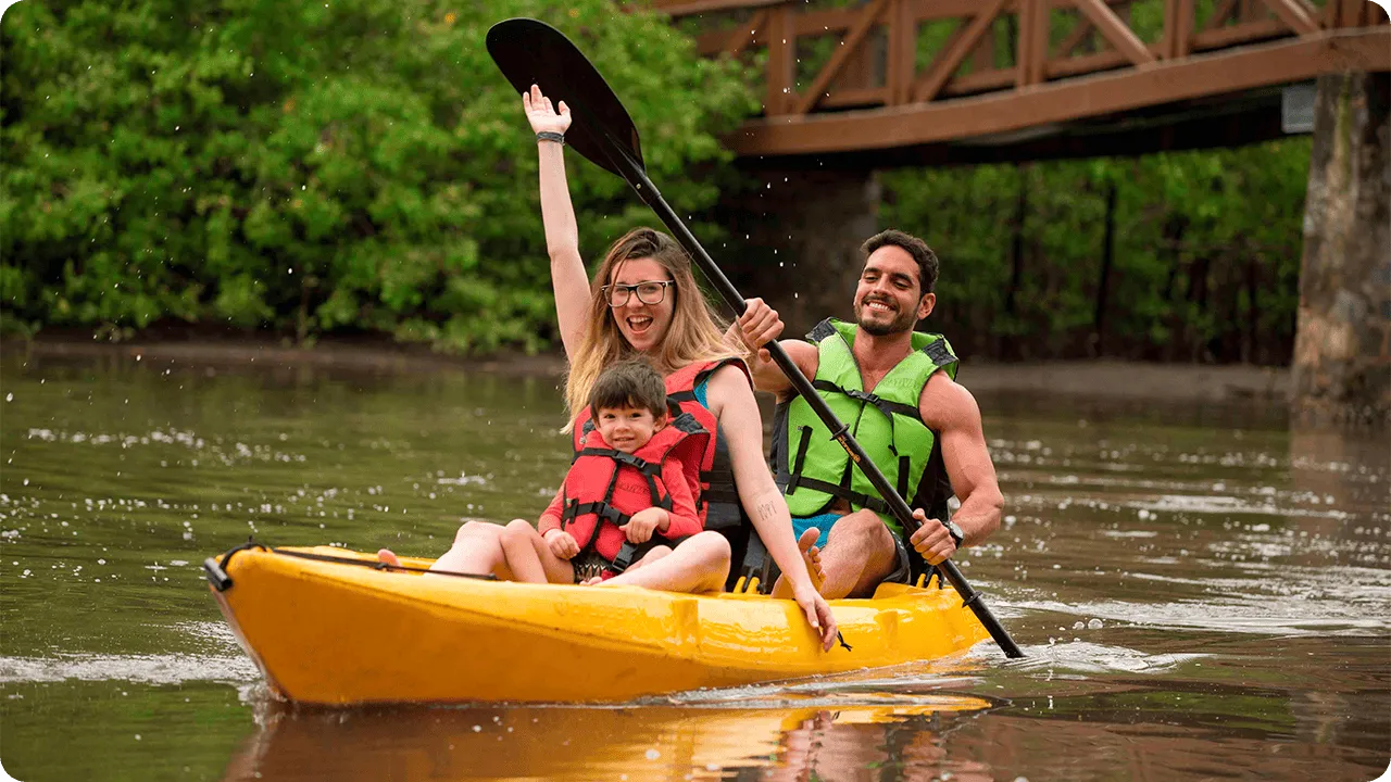 Family having fun on a kayaking trip on the Maragogi River