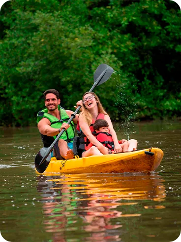 Family having fun on a kayaking trip on the Maragogi River