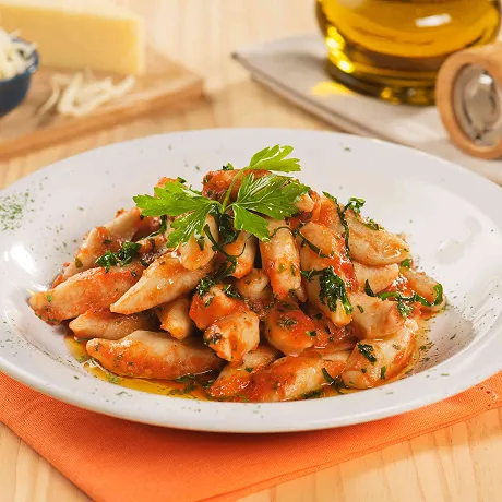 Prato de nhoque com molho de tomate e queijo como parte da oferta do sistema all inclusive.