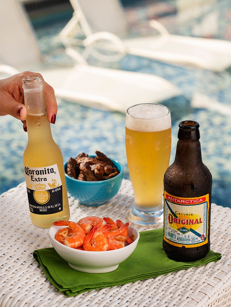 Petiscos com camarão e bebidas geladas servidos à beira da piscina no Salinas Maceió.