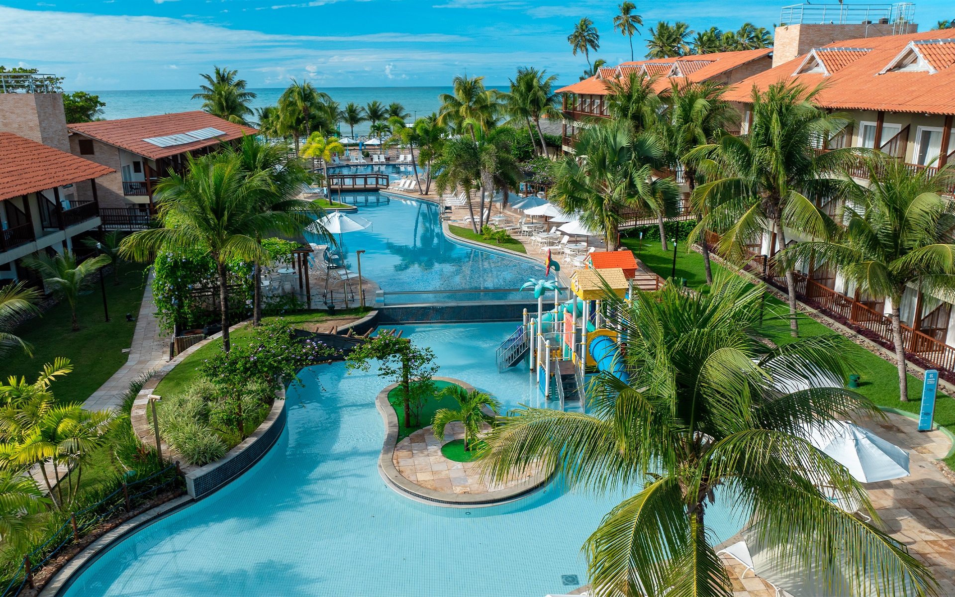 vista-aérea-salinas-maceió Vista aérea do Salinas Maceió, com bloco de apartamentos nas laterais, área de lazer com piscinas ao centro, com bastante coqueiros e áreas verdes e ao fundo a praia de Ipioca.